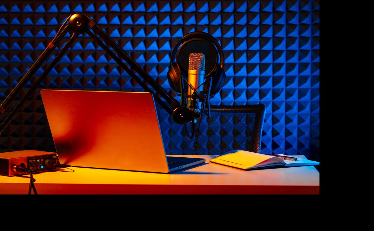 Professional recording studio with a microphone, laptop and notebook