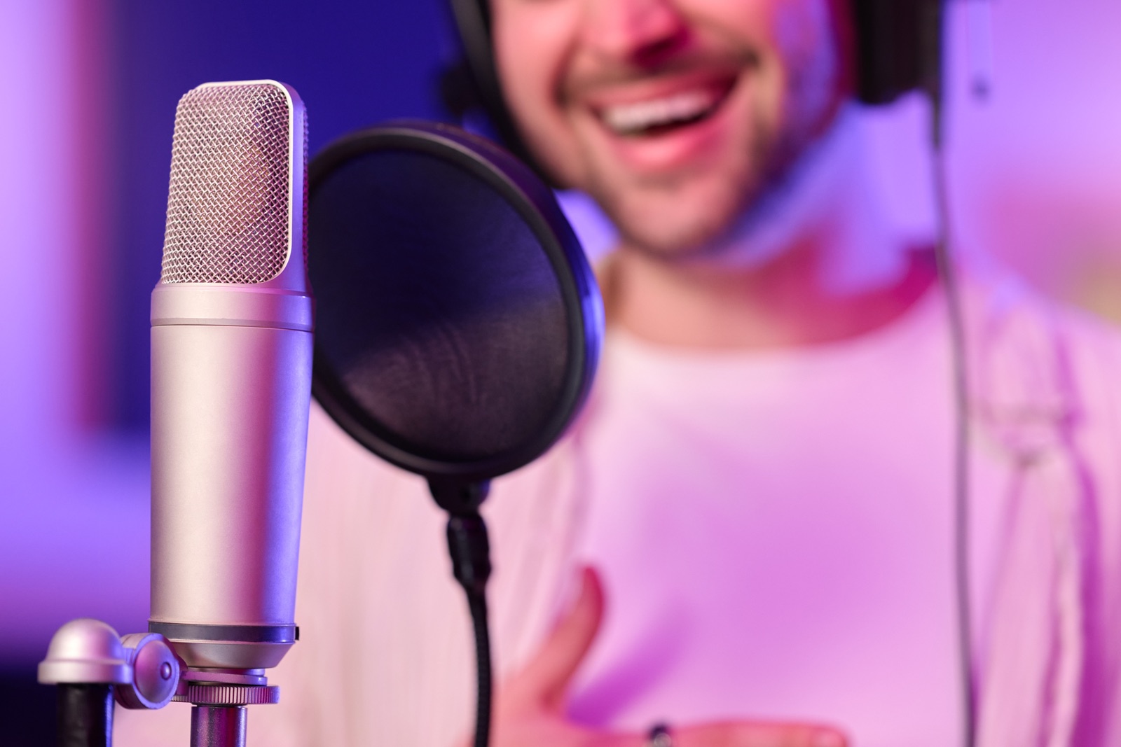 Voice-over artist recording narration with a studio microphone